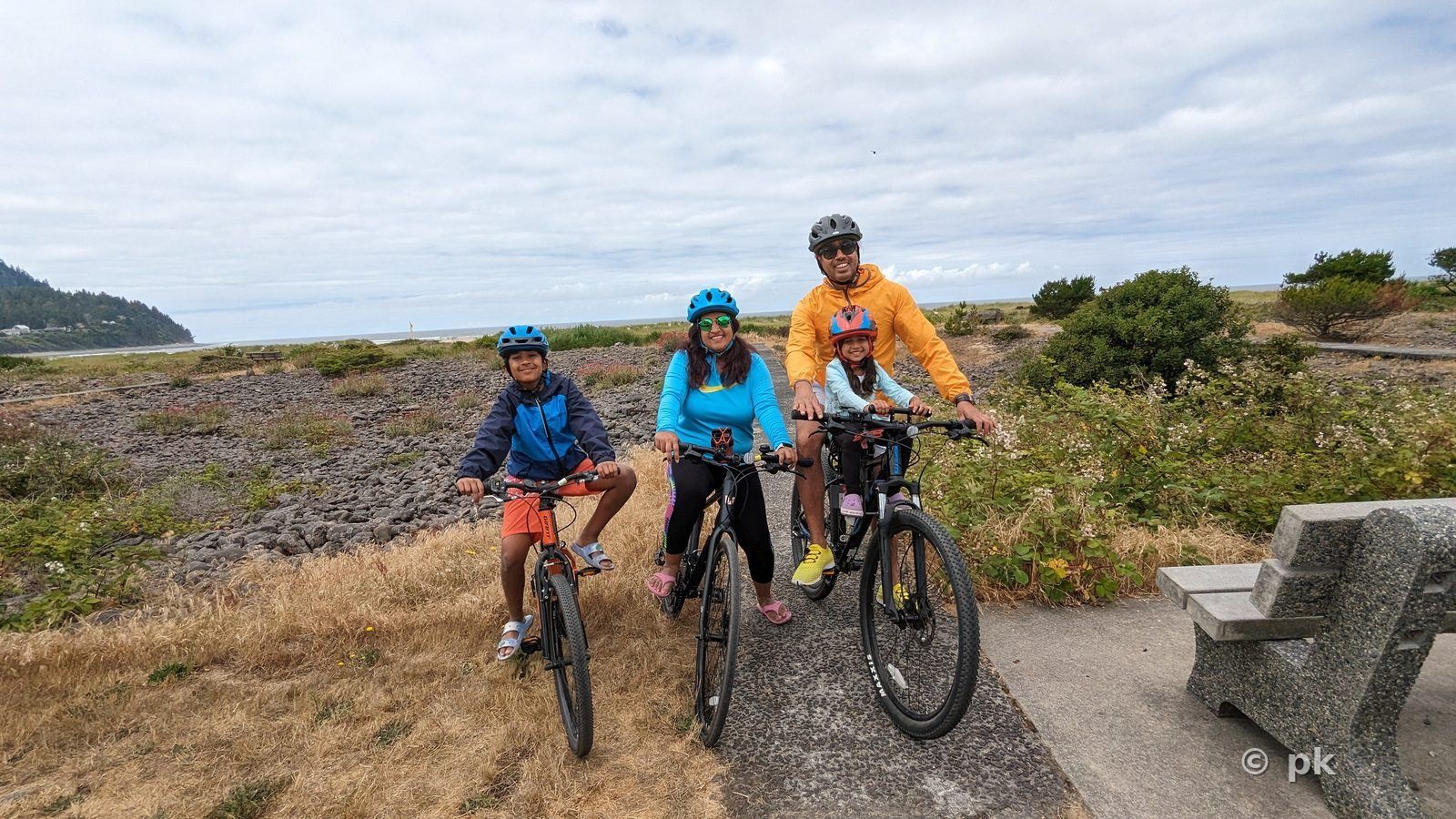 Family on a bike ride along a coastal trail